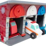 An emergency vehicle garage with an ambulance, police car, and fire truck. All wooden toys